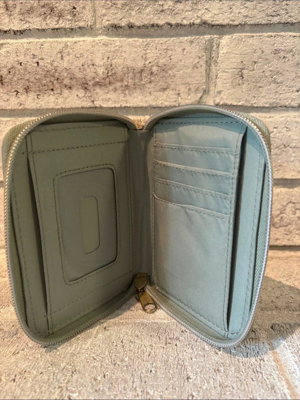 Loungefly Harry Potter Zip Card Holder with Deathly Hallows emblem.